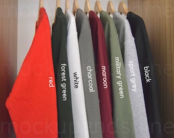 May include: A row of ten sweatshirts hanging on a rack, each in a different colour. The colours are red, forest green, white, charcoal, maroon, military green, sport grey, and black.