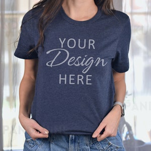 May include: A navy blue t-shirt with the text "YOUR Design HERE" printed on the front.