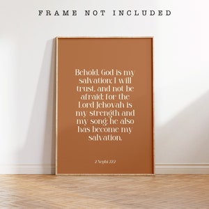 May include: A framed print with a warm terracotta background and white text. The text reads, "Behold, God is my salvation; I will trust, and not be afraid..." with a reference to 2 Nephi 22:2. The frame is not included.