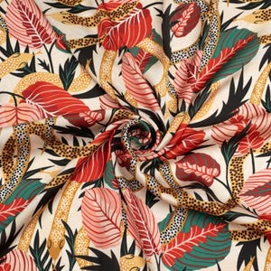 May include: A fabric featuring a repeating pattern of winding snakes with yellow and black spotted skin, interspersed with large red, pink, and dark green tropical leaves on a cream-coloured background, arranged in a swirling, gathered design.