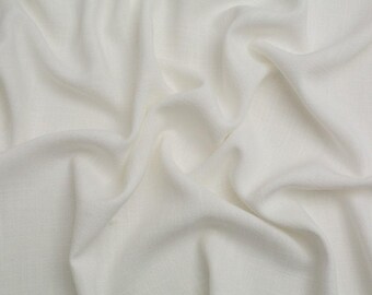 May include: A solid white fabric with a visible woven texture, featuring soft, flowing folds and deep, natural drapes that create a series of gentle shadows and highlights across the surface of the material, emphasizing its lightweight quality.