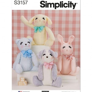 May include: Simplicity sewing pattern S3157 featuring four plush stuffed animals: a yellow rabbit, a light blue bear, a pink rabbit, and a grey and white dog. Each animal has embroidered facial features, long eyelashes, and a small patterned bow.