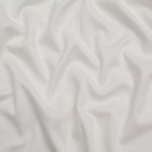 May include: A solid white fabric with a soft, matte texture, featuring deep, flowing folds and gentle ripples that create a dynamic play of light and shadow across the surface, emphasizing the smooth, consistent, and opaque nature of the material.