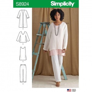 May include: Simplicity sewing pattern S8924 featuring line drawings of a long cardigan, a V-neck top, a sleeveless tank, and trousers. The image displays a layered outfit consisting of a white textured long-sleeve top over a pink tunic and white trousers.