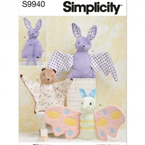 May include: A Simplicity S9940 sewing pattern envelope featuring illustrations of three plush toys: a lavender bat with patterned wings, a tan bat with a spotted wing pattern, and a light green butterfly with pink wings and blue and yellow spots.