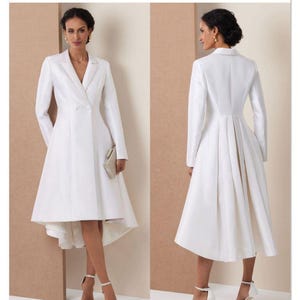 Puede incluir: Sobre de patrón de costura Vogue Patterns V2125 que muestra un vestido abrigo blanco con solapa de muesca, cierre de doble botonadura, mangas largas y un dobladillo asimétrico con diseño de falda trasera plisada. El texto V2125 y VOGUE PATTERNS es visible.