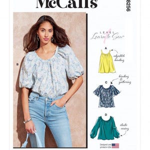 May include: McCall's M8256 sewing pattern envelope featuring a Learn to Sew Level 1 guide. The front displays a light blue and white floral print blouse with puff sleeves, alongside technical illustrations for variations A, B, C, and D.