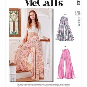 May include: McCall's sewing pattern M8223 with wide-leg trousers. The pattern includes multiple view options. The image shows a woman wearing floral print trousers. Size Y (XS-S-M).
