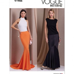 May include: Vogue Patterns V1986 sewing pattern envelope featuring two floor-length skirt designs. One view shows a bright orange high-waisted skirt with a flared hem, and the other shows a black skirt with a paneled design and a flared hem.