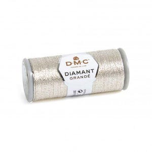 May include: A spool of metallic silver embroidery thread by D.M.C. The label features the D.M.C logo with a horse icon and the text DIAMANT GRANDE. The thread is wound tightly around a cylindrical spool with grey plastic end caps.
