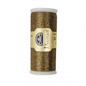 May include: A spool of metallic gold embroidery thread with a white plastic core. The central label features the text DMC and Diamant in black lettering on a gold background, with additional small printed details visible on the label surface.