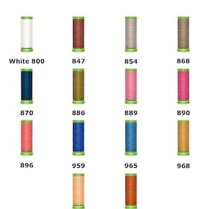 May include: Gütermann Extra Fine Sewing Thread 200m spools in a grid of 14 colors. Each spool features a green base and top with the brand name. Colors include white, brown, gray, taupe, dark blue, olive, pink, magenta, coral, blue, teal, gold, peach, and orange.