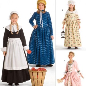 May include: Simplicity 3725 sewing pattern envelope featuring four historical-style costumes. Designs include a black and white colonial dress, a blue polka-dot dress with a bonnet, a floral print dress with a shawl, and a pink and floral gown.