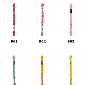 May include: D.M.C. Size 5 Cotton Perle Thread in six colors. The skeins are labeled 961, 962, 963, 966, 972, and 973. The colors include shades of pink, light pink, pale pink, light green, yellow, and bright yellow, each with a paper label.