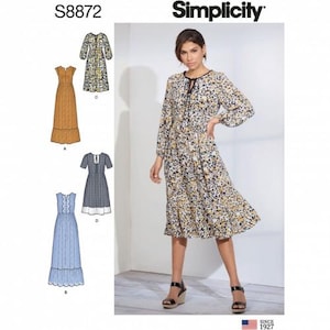 May include: A sewing pattern for a dress with four different styles. The pattern is called Simplicity S8872. The dress is shown in four different fabrics: a brown floral print, a blue and white plaid, a light blue floral print, and a white floral print.