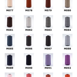 May include: A collection of Coats Moon sewing thread cones, each containing 4500m of thread. The image displays twenty individual cones in various colours, labelled with codes from M077 to M096, arranged in a grid against a plain white background.
