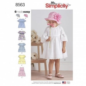 May include: Simplicity pattern 8563 6madeeasy features a white eyelet dress with bell sleeves and a pink polka dot hat with a large flower. The pattern includes six variations of dresses and hats shown in illustrations on the left side of the package.