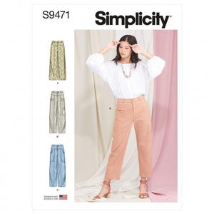 May include: Simplicity sewing pattern S9471 features a white long-sleeve blouse and three variations of trousers. View A shows floral print trousers, View B displays solid peach trousers with side pockets, and View C shows solid light blue trousers.