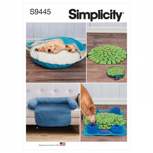 May include: Simplicity pattern S9445 showcasing dog beds and enrichment toys. The image displays a blue and white dog bed, a green snuffle mat, a blue sofa cover, and a dog interacting with a puzzle toy. Designed and printed in the USA.