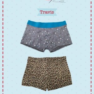 May include: A sewing pattern for underwear and swimming trunks titled Flo-Jo Travis. The image displays two pairs of shorts: one gray pair with a small white and black triangle pattern and a blue waistband, and one pair with a brown leopard print.
