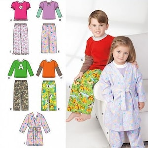 May include: Simplicity 1573 sewing pattern for children's clothing including shirts, trousers, and a robe. The pattern features various designs labelled A through F, showing options for short and long sleeves, patterned trousers, and a belted robe.