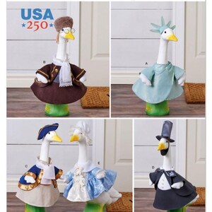May include: Simplicity pattern S3224 featuring five white goose figurines dressed in various outfits. One wears a brown coat and fur hat, another a light blue Statue of Liberty costume, a colonial blue coat, a blue dress, and a black tuxedo with top hat.