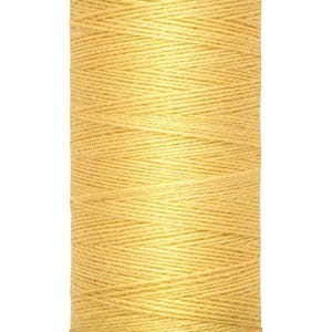 May include: A spool of yellow sewing thread by Gütermann. The cylindrical spool features a light yellow plastic top and bottom with the brand name printed on the top and the length of 200 m - 220 yds/vgs printed on the bottom base.
