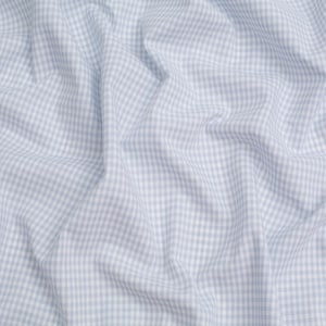 May include: A close-up of a light blue and white gingham fabric with a wrinkled texture.