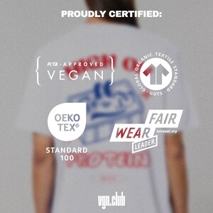 May include: A white t-shirt with various certifications printed on it, including PETA Approved Vegan, Global Organic Textile Standard (GOTS), OEKO-TEX Standard 100, and Fair Wear Leader. The text "vgn.club" is printed on the bottom of the shirt.