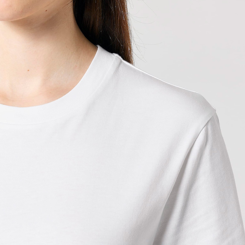 May include: White short-sleeved t-shirt with a crew neck.