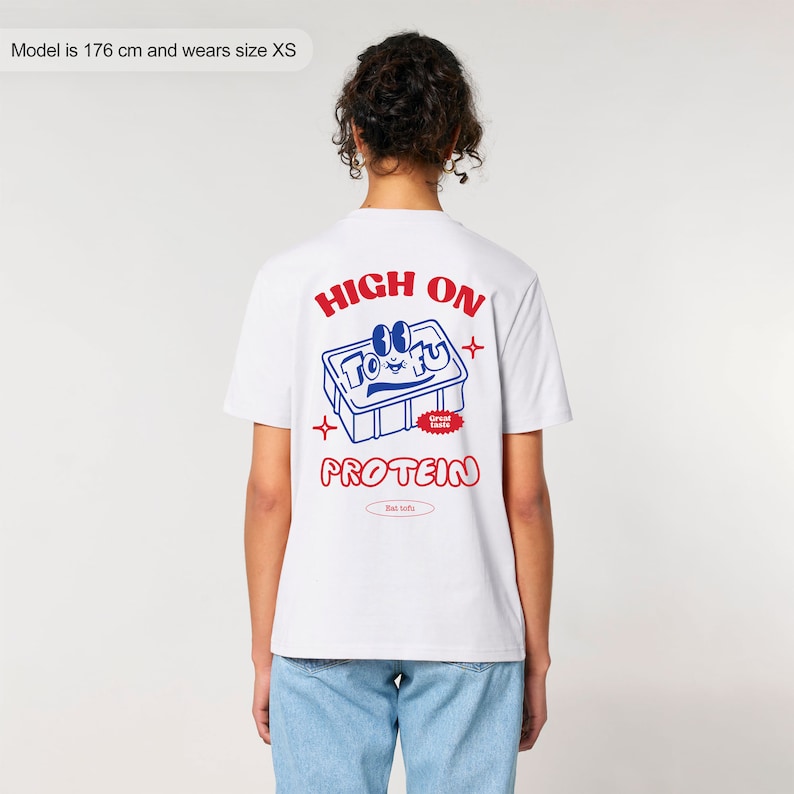 May include: White t-shirt with a blue and red graphic of a tofu block with the text "HIGH ON TOFU PROTEIN" and "Great Taste!" and "Eat Tofu!"