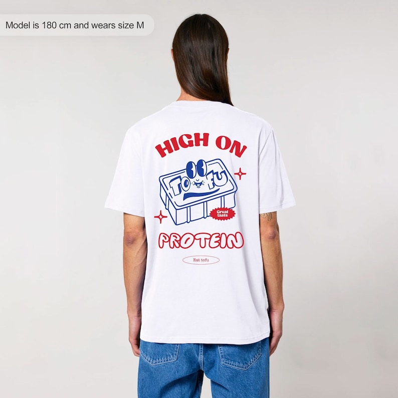 May include: White t-shirt with a red and blue graphic on the back that says "HIGH ON TOFU Great Taste PROTEIN Bat tofu".
