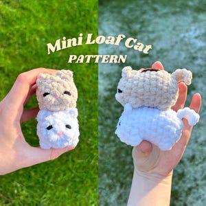 May include: Two crocheted cat toys stacked on top of each other. The top cat is beige and the bottom cat is white. The cats are in the shape of a loaf of bread. The image is titled "Mini Loaf Cat Pattern".
