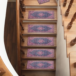 May include: A set of five purple and blue patterned stair treads with a diamond design. The treads are placed on a wooden staircase.
