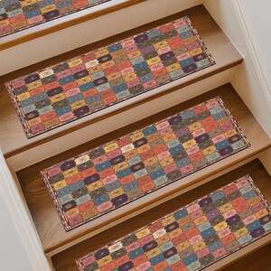 May include: Stair treads with a colourful, geometric pattern. The treads feature a repeating design of rectangular blocks in shades of blue, orange, yellow, and purple. The stair treads are placed on wooden stairs.