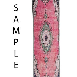 May include: A pink and green patterned rug with a traditional design. The rug has a grey border and is made of a soft, durable material.
