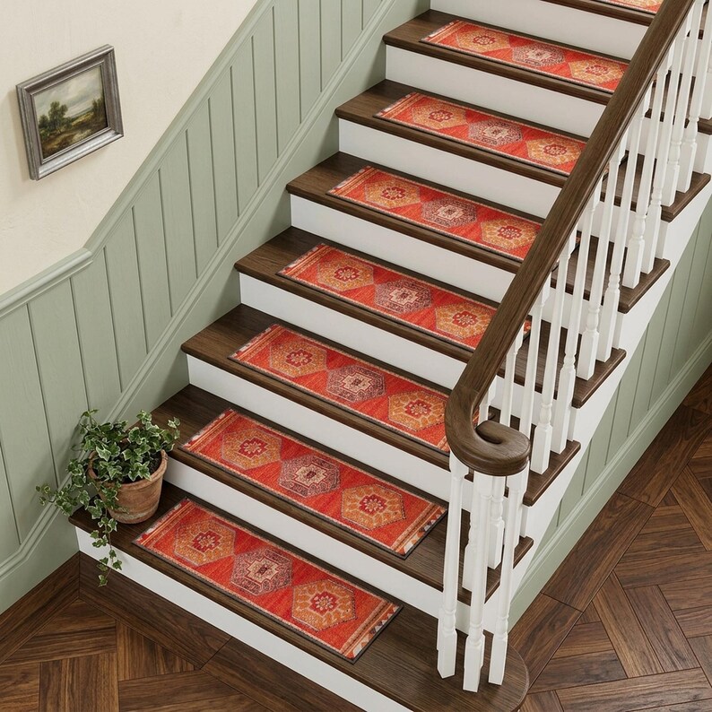 a set of wooden stairs with a white railing, leading up to a higher level. The stairs are adorned with red and orange patterned rugs, and a potted plant is placed on the steps. The overall scene has a warm and inviting atmosphere.