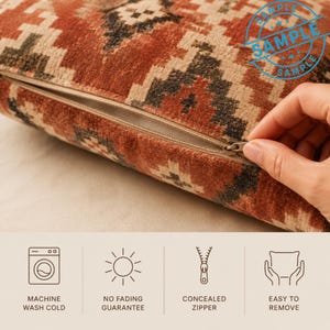 a hand holding a zipper on a pillow with a patterned design. The pillow appears to be machine washable and has a no fading guarantee. The pillow also has a zipper that is concealed, making it easy to remove.
