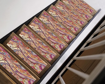 May include: A set of wooden stair treads with a colourful, abstract marbled pattern. The pattern features swirls of pink, orange, yellow, blue, and green.