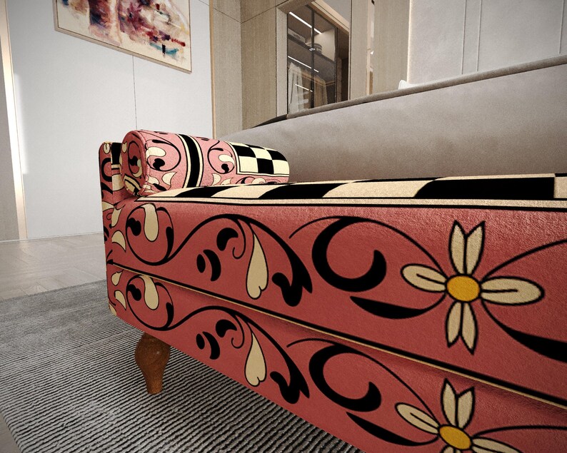 a colorful, patterned sofa with a floral design in pink, black, and white.