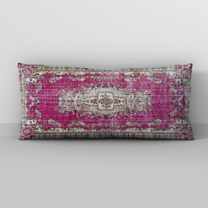 May include: A pink and cream patterned throw pillow with a vintage rug design.