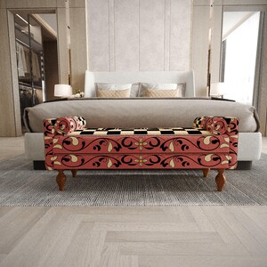 a modern bedroom with a large bed, a red and black patterned bench, and a gray and white rug on the floor.