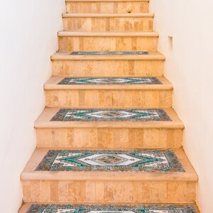 May include: A set of beige tiled stairs with green and blue patterned rugs on each step.