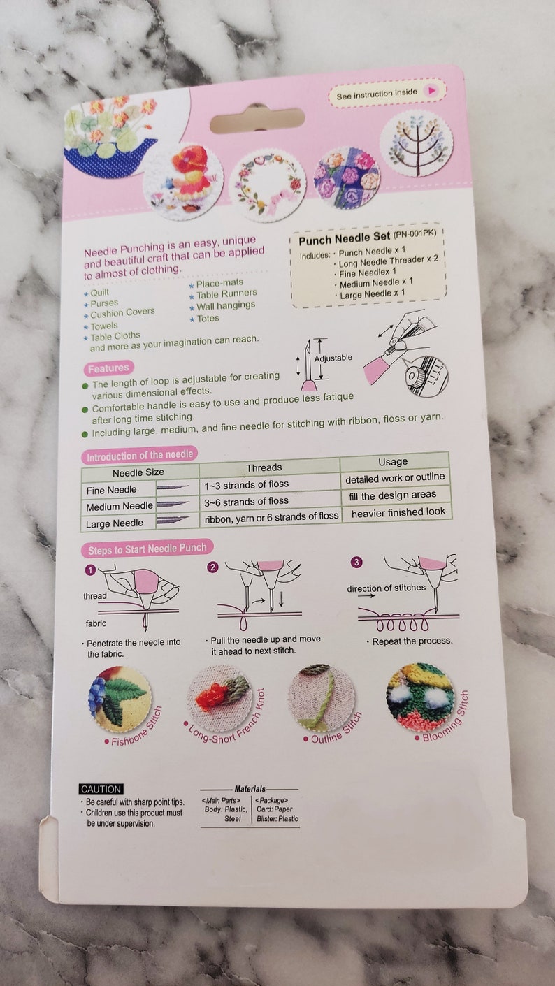 May include: Punch needle set with instructions on how to use the needles for different types of stitches. The set includes a punch needle, a long needle threader, a fine needle, a medium needle, and a large needle. The set is packaged in a white and pink cardboard box.