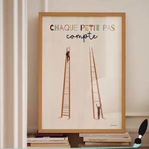 May include: Framed art print featuring two ladders, one with a person climbing and the other with a person reaching up. The text "CHAQUE PETIT PAS compte" is at the top in colorful letters. The artwork is in a wooden frame.
