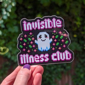 May include: A black and pink sticker with a pixelated ghost and the text "invisible illness club".