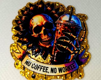May include: A gold glitter sticker featuring a skull with a sunflower crown and a skeleton hand holding a coffee cup. The banner reads "NO COFFEE, NO WORKE". The skull is orange, blue, and black.