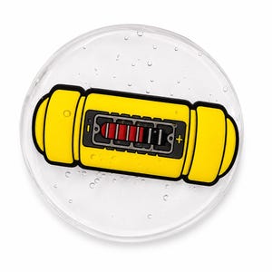 May include: A circular clear coaster featuring a yellow, capsule-shaped graphic with a black border. The graphic displays a central rectangular interface with four red vertical bars, a black background, and a yellow plus sign on the right side.