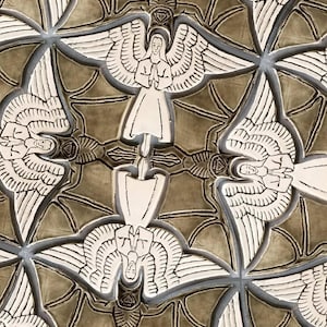 May include: A brown ceramic tile with a repeating pattern of white angels with wings. The angels are in a symmetrical design, with their wings overlapping.