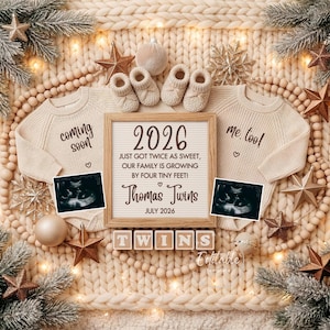 May include: A beige baby announcement with two sweaters, baby booties, and a sign that reads "2026 Just got twice as sweet, our family is growing by four tiny feet! Thomas Twins July 2026." The word "Twins" is spelled out with blocks.